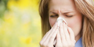 USA, New York, New York City, Manhattan, Central Park, Close up of woman sneezing